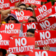 Protesters hold placards as they stage protest an extradition law in Hong Kong on June 9, 2019